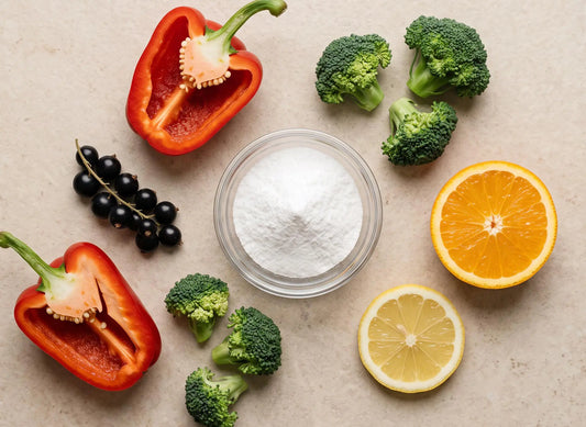 Paprika, Brokkoli, Johannisbeeren, Orange und Zitrone um eine Schale Vitamin-C-Pulver angeordnet